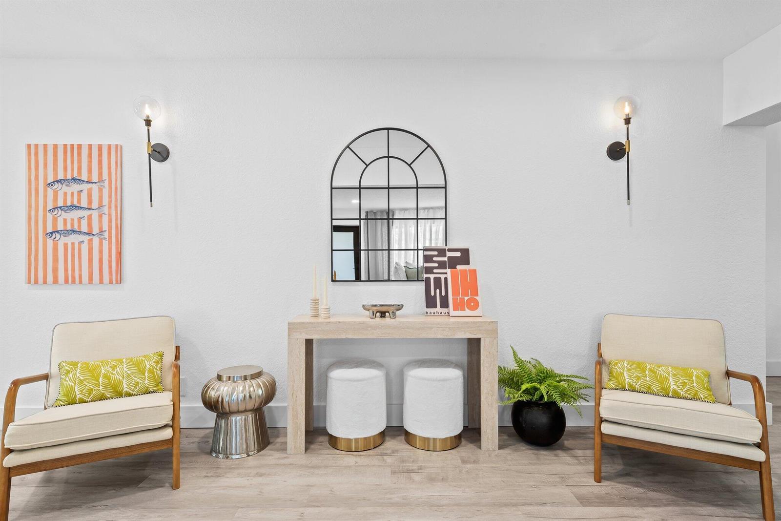 A symmetrical entryway features two armchairs, a console table with two stools, and wall sconces — 581 SE 5th Avenue, Pompano Beach FL 33060, POMPANO BEACH, FL