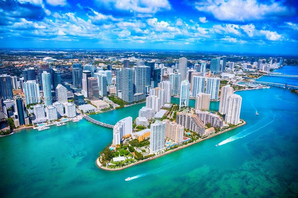 An aerial view of the Miami skyline and Brickell Key surrounded by turquoise water — 800 Claughton Island Dr # 502, Miami FL 33131, MIAMI, FL