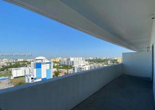 A high-rise balcony overlooks a city skyline under a clear blue sky — 36 NW 6th Ave # 603, Miami FL 33128, MIAMI, FL
