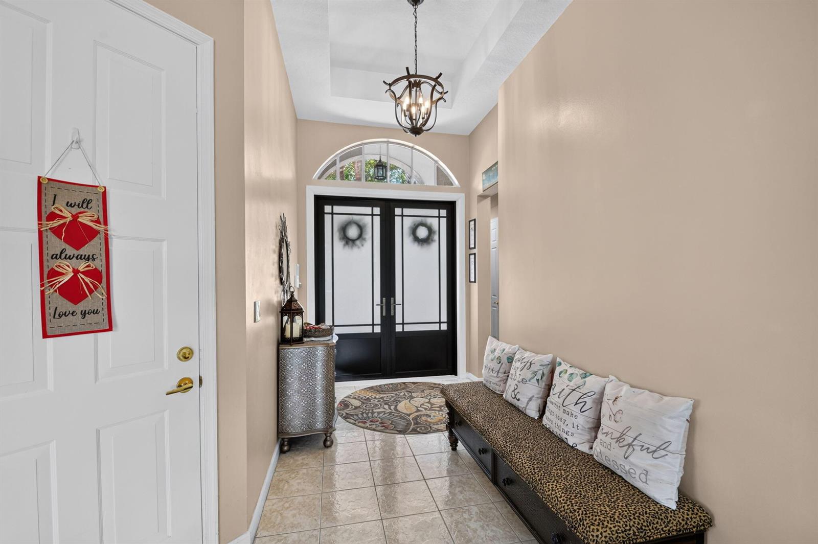 An entryway features a double front door, a chandelier, a bench, and tile flooring — 2142 Balsan Way, Wellington FL 33414, WELLINGTON, FL
