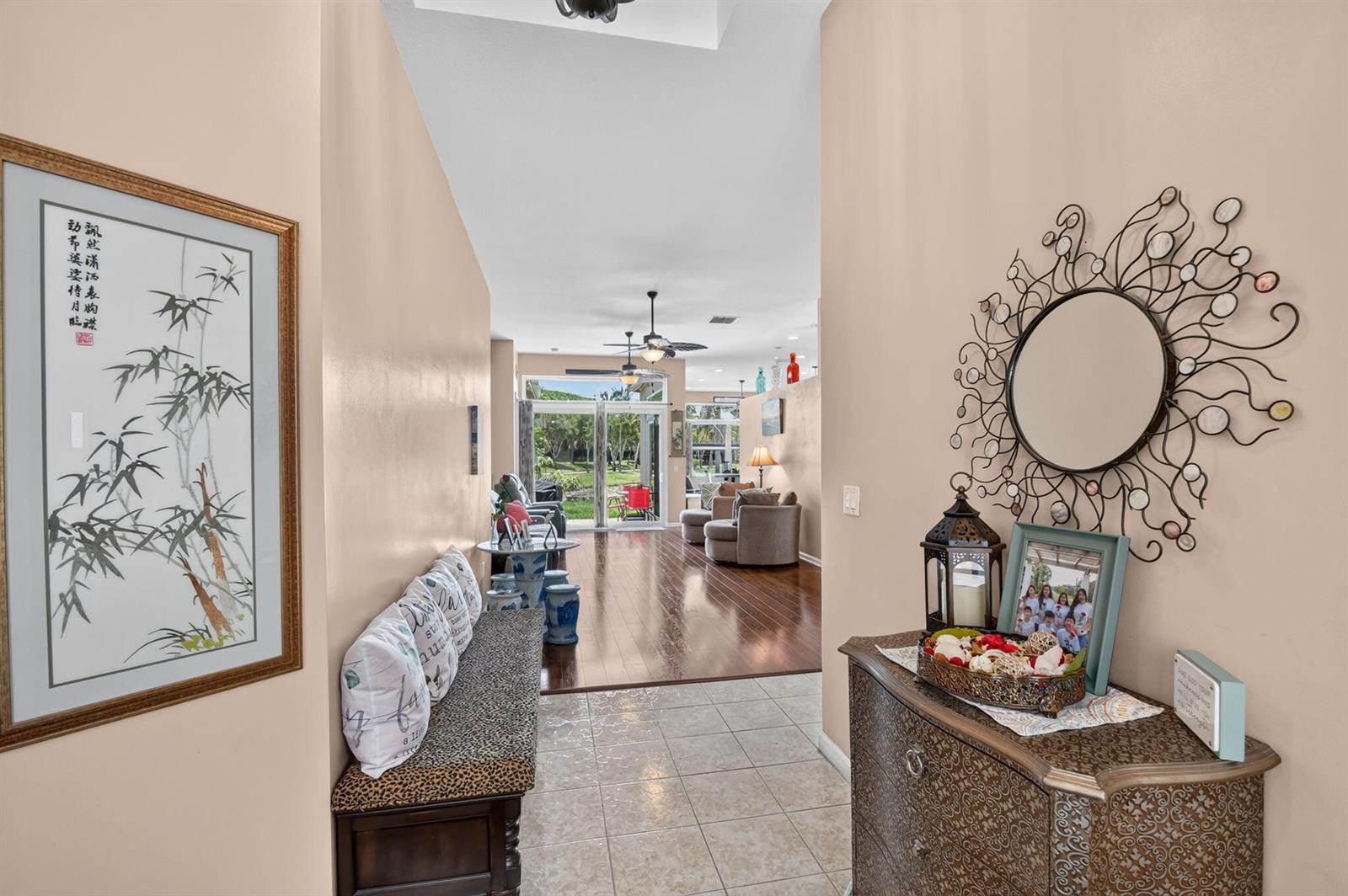 A tiled entryway leads into a living area with hardwood floors and sliding glass doors — 2142 Balsan Way, Wellington FL 33414, WELLINGTON, FL