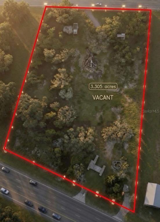 An aerial view shows a 3.305-acre vacant lot outlined in red along a road — 24368 DORSEY SMITH ROAD, BROOKSVILLE, FL