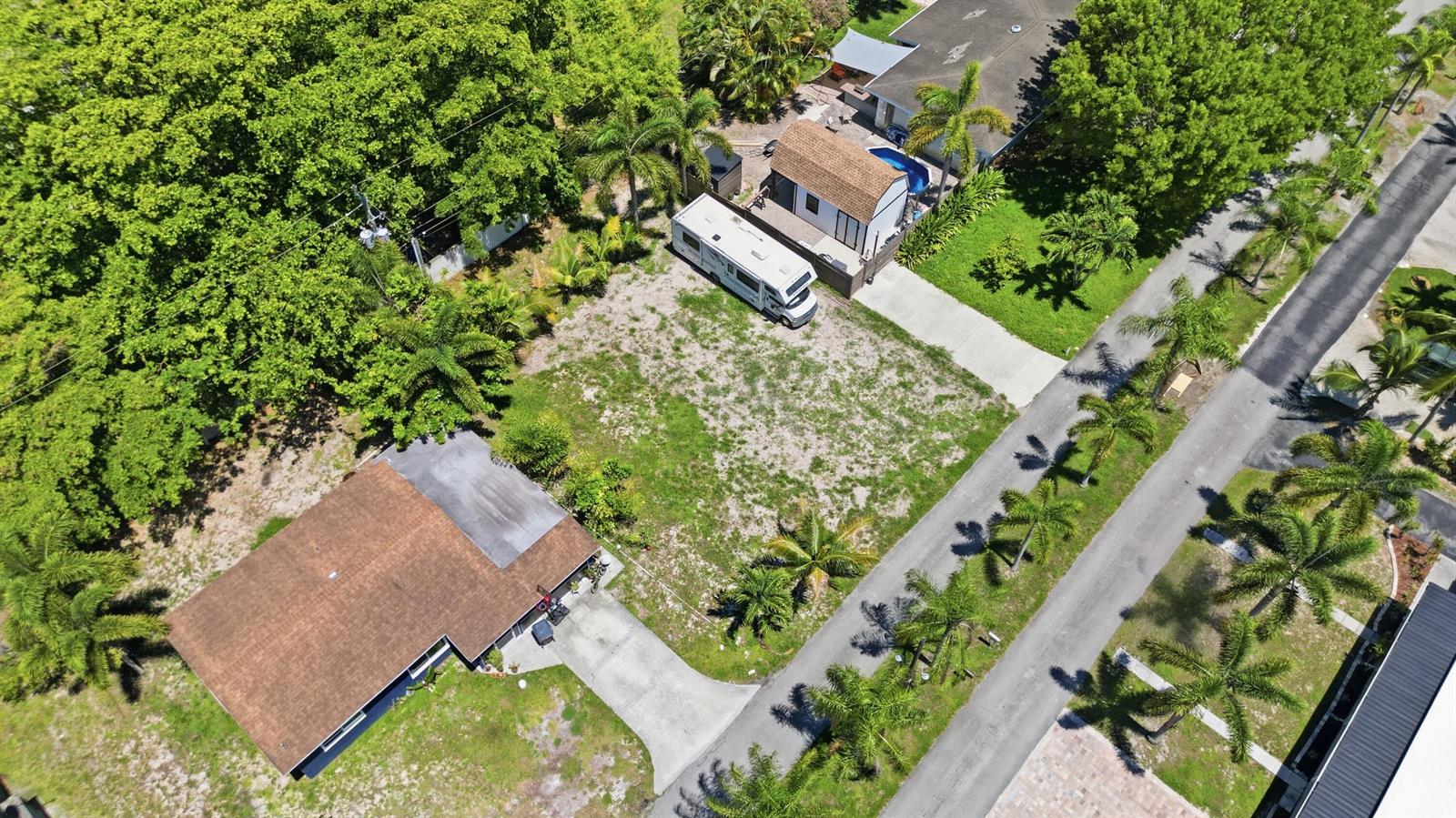 An aerial view shows a residential lot with a house, a detached structure, and an RV — 000 Morrison Avenue, FL 33463, FL