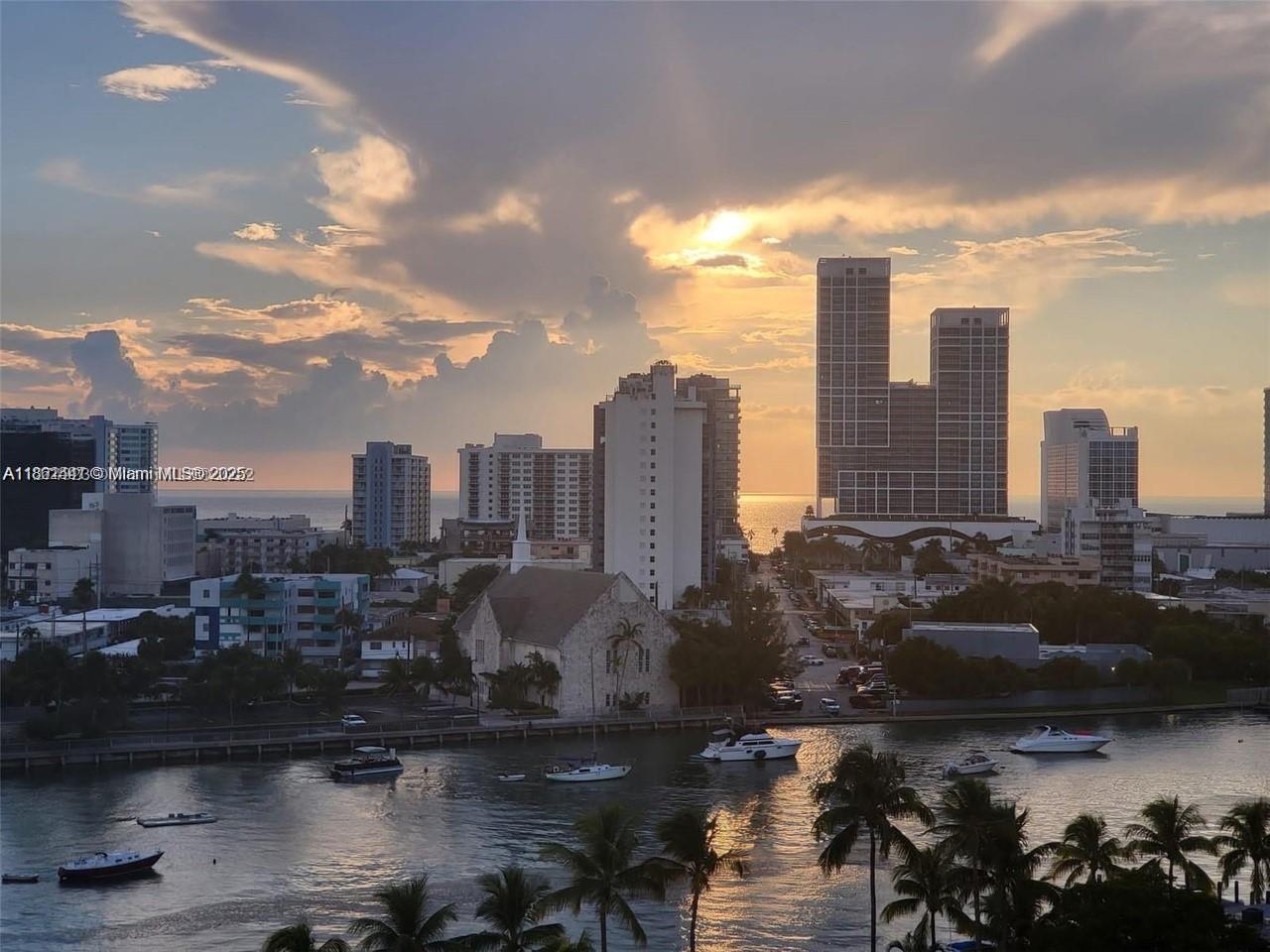 An elevated view of a city skyline and waterway at sunset with several boats — 6900 Bay Dr # 11F, Miami Beach FL 33141, MIAMI BEACH, FL