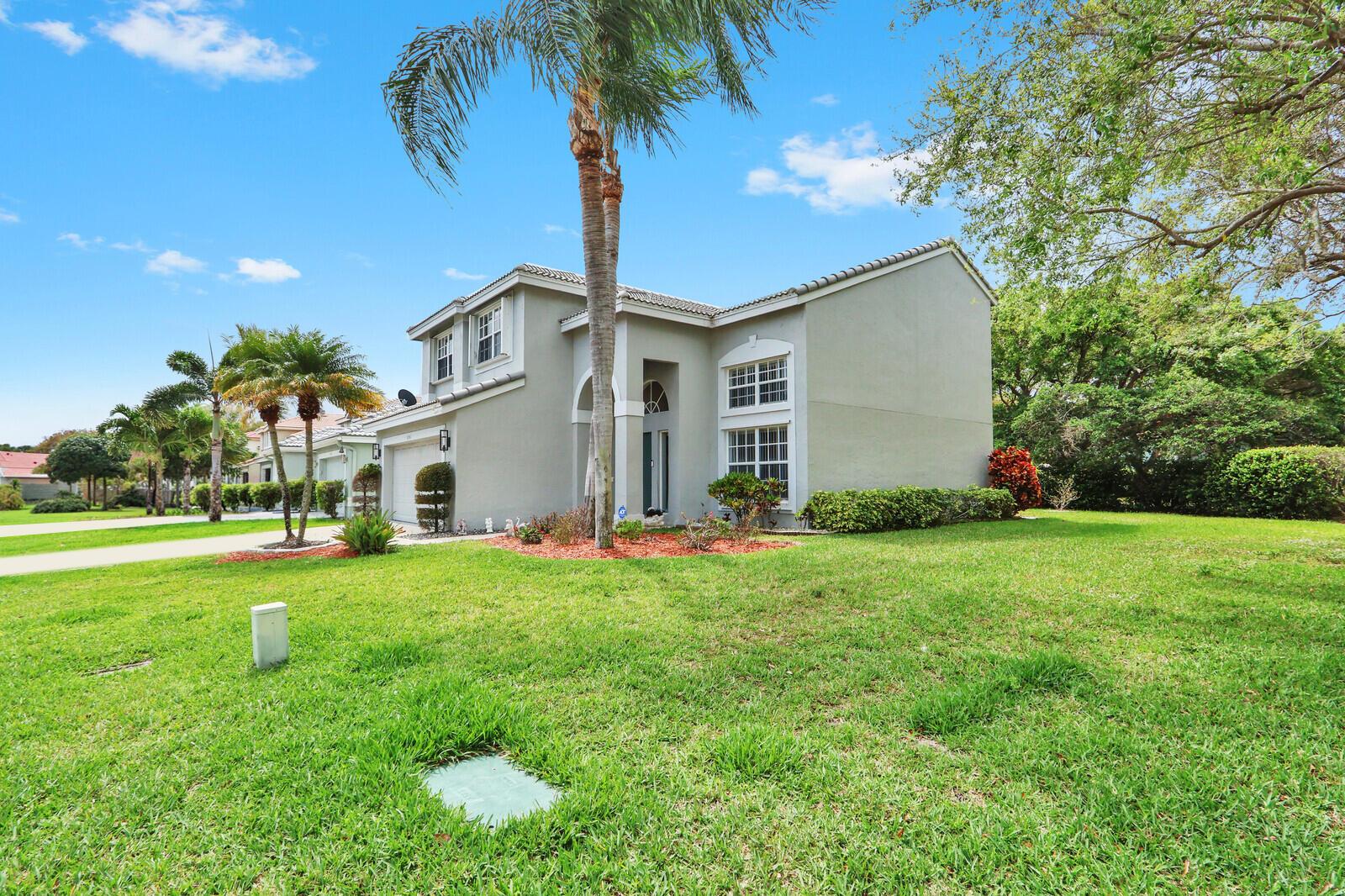 A two-story house with a gray stucco exterior, a palm tree, and a green lawn — 8156 Mystic Harbor Circle, Boynton Beach FL 33436, BOYNTON BEACH, FL