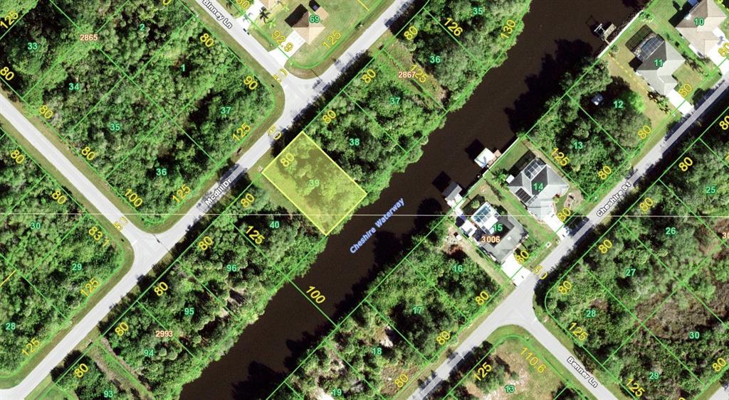 This is an aerial map showing a vacant lot highlighted in yellow along a waterway — 610 MCDILL DRIVE, PORT CHARLOTTE, FL