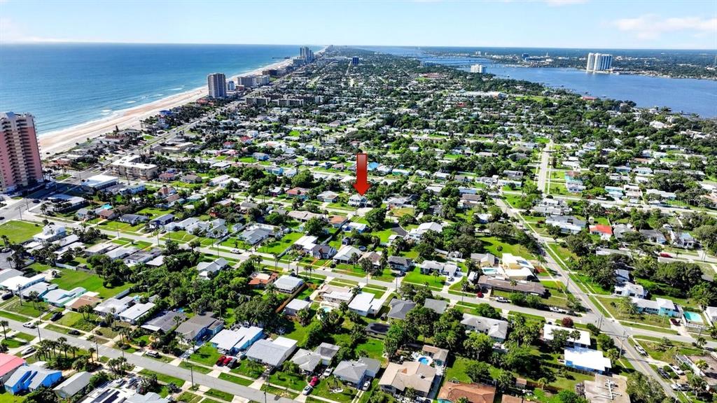 An aerial view shows a residential neighborhood near the coast with a red arrow pointing down — 330 HARTFORD AVENUE, DAYTONA BEACH, FL