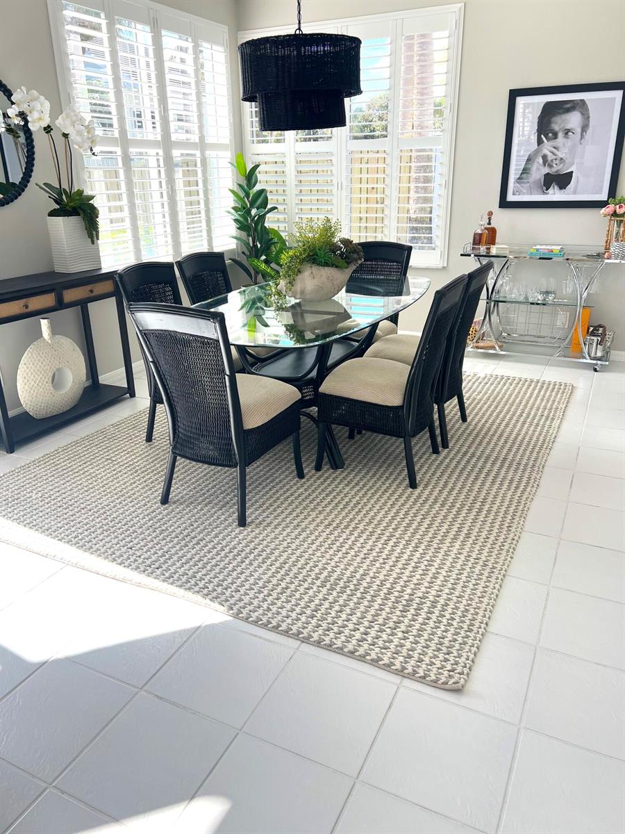 A dining room features a glass-topped table, black wicker chairs, and a textured area rug — 3028 Windward Way, Jupiter FL 33477, JUPITER, FL