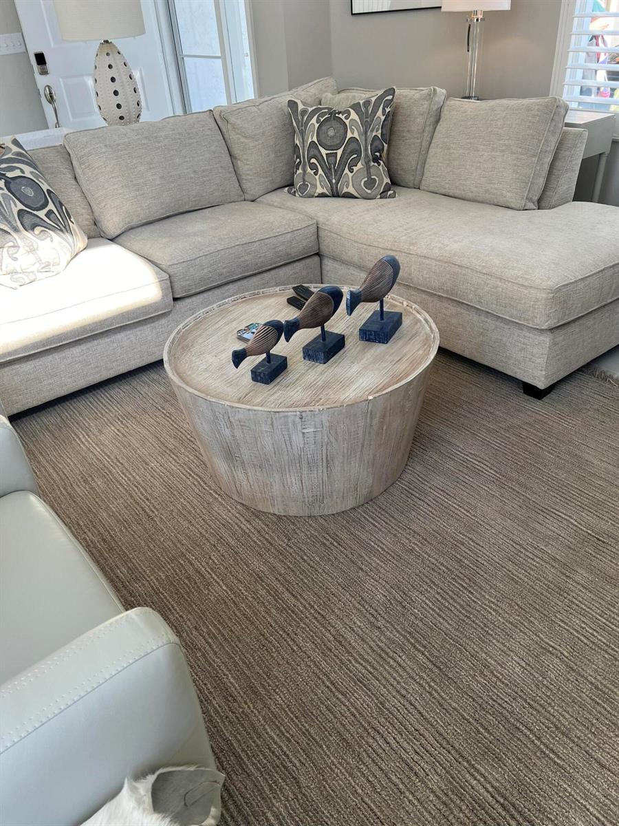 A living room features a beige sectional sofa, a round wooden coffee table, and area rug — 3028 Windward Way, Jupiter FL 33477, JUPITER, FL