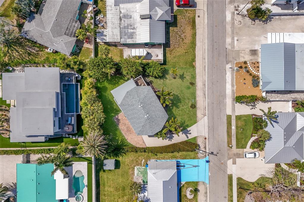 An aerial view shows several residential houses with pools and driveways along a paved street — 221 85TH STREET, HOLMES BEACH, FL