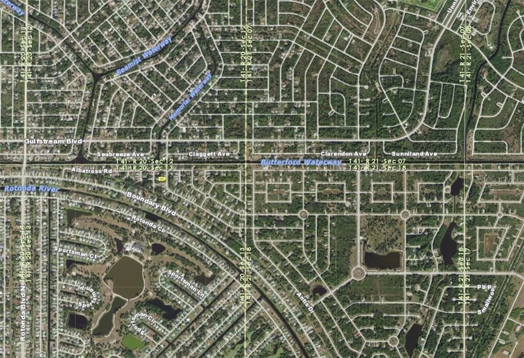 This is an aerial map view of a residential neighborhood with streets and waterways — 107 JENNIFER DRIVE, ROTONDA WEST, FL