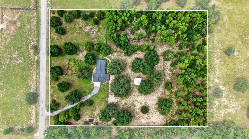 An aerial view shows a house and a small shed on a wooded, fenced lot — 11281 N CIRCLE M AVENUE, DUNNELLON, FL
