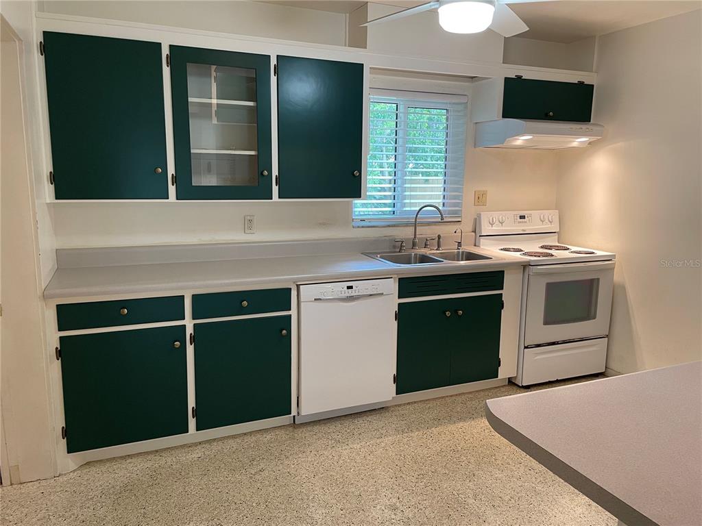 An empty room with light-colored walls, a ceiling fan, a window, and tiled flooring — 640 47TH STREET, SARASOTA, FL
