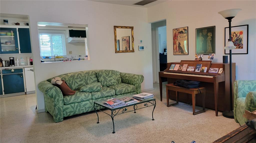 A sunken dining room features wood flooring, a hutch, and a white front door — 640 47TH STREET, SARASOTA, FL