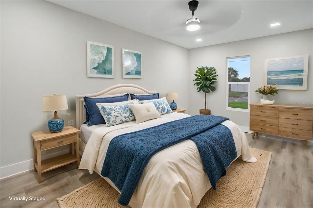 A spacious open-concept kitchen and living area with light wood flooring and white cabinetry — 728 SPANISH MAIN DRIVE, APOLLO BEACH, FL
