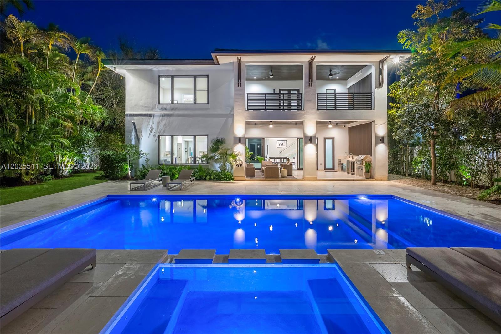 A two-story house with a swimming pool, hot tub, and covered patio at night — 5753 SW 31st St, Miami FL 33155, MIAMI, FL