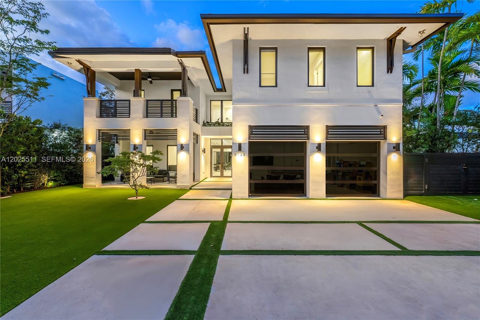 A modern two-story house features a two-car garage, balconies, and a paved driveway with grass — 5753 SW 31st St, Miami FL 33155, MIAMI, FL
