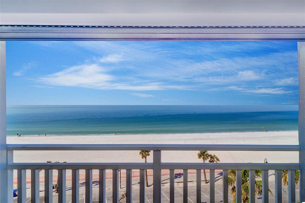 A view of the beach and ocean from a balcony with a white railing — 555 GULF WAY UNIT 7N, ST PETE BEACH, FL