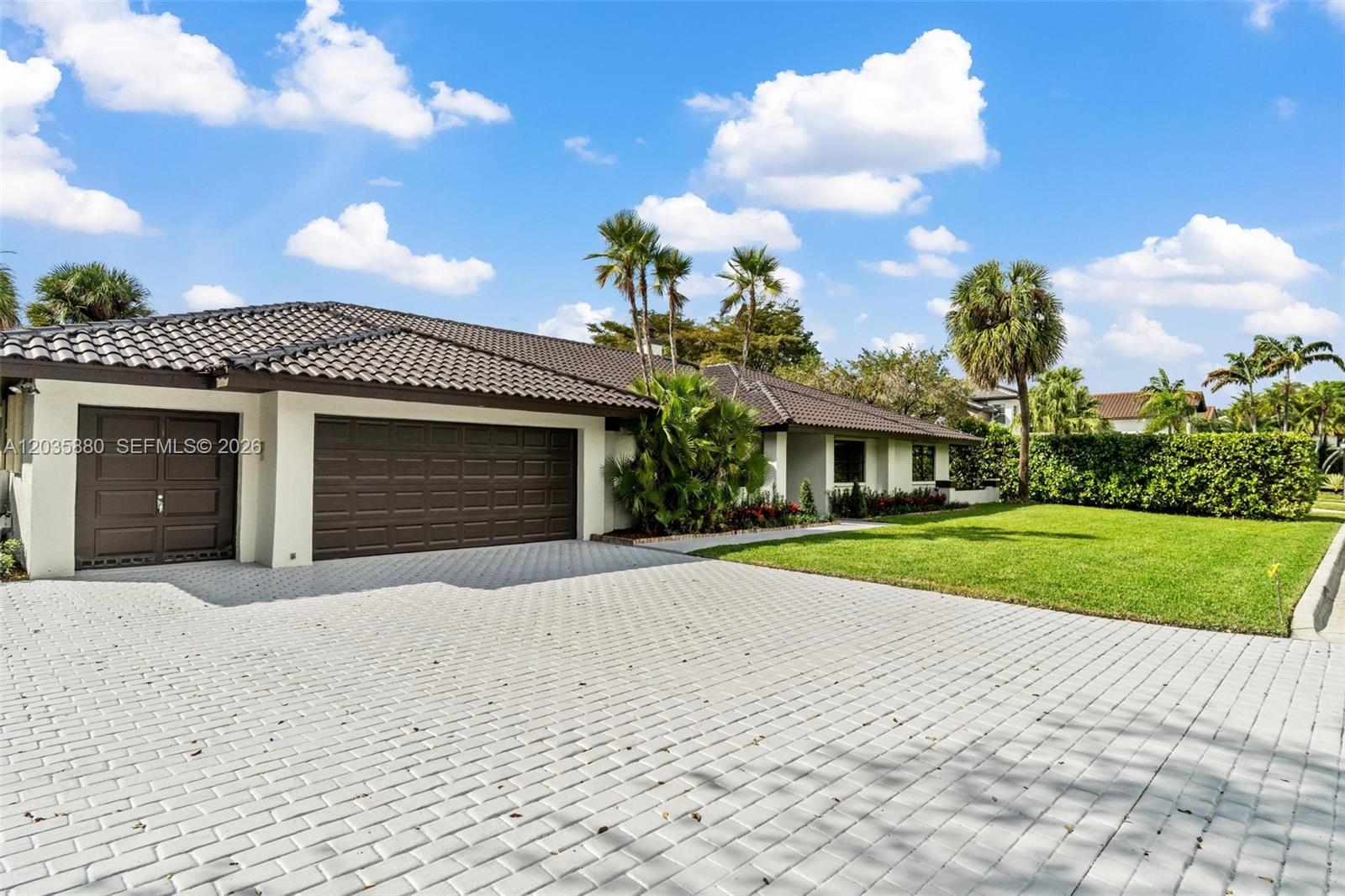 A single-story house features a brown tiled roof, a two-car garage, and a paved driveway — 5254 NW 94th Doral Pl, Doral FL 33178, DORAL, FL