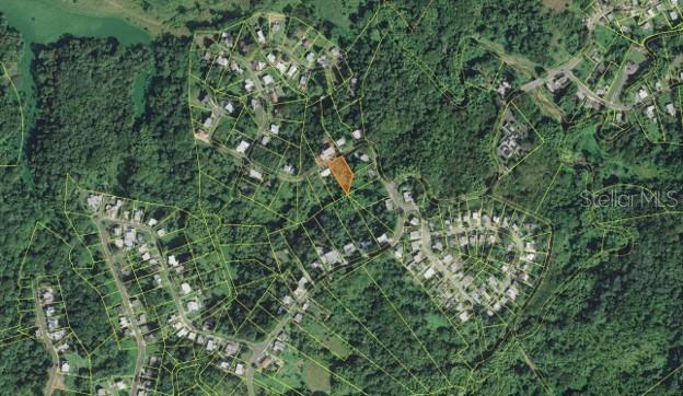 An aerial map view shows a highlighted plot of land within a residential neighborhood — LOT#50 MIRADERO GARDENS DEV., PITIRRE ST., MAYAGUEZ, PR