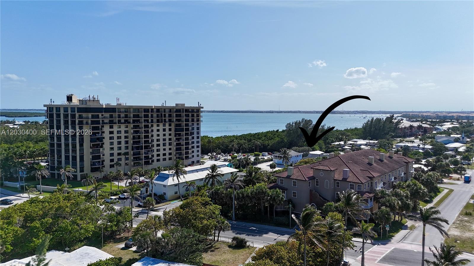 An aerial view shows a multi-story residential building near a body of water — 742 Granada St # A, Fort Pierce FL 34949, FORT PIERCE, FL