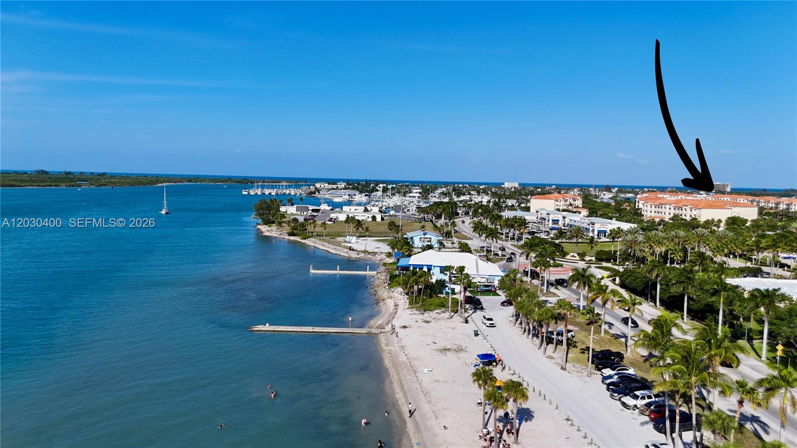 An aerial view shows a coastal area with a beach, marina, and a large building — 742 Granada St # A, Fort Pierce FL 34949, FORT PIERCE, FL