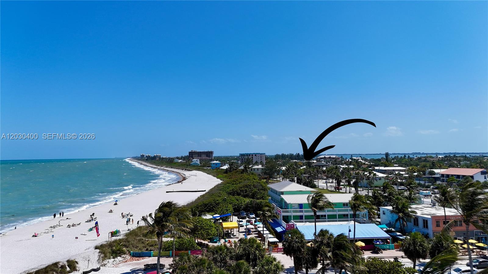 An aerial view shows a beach, palm trees, and a multi-story building with a blue roof — 742 Granada St # A, Fort Pierce FL 34949, FORT PIERCE, FL