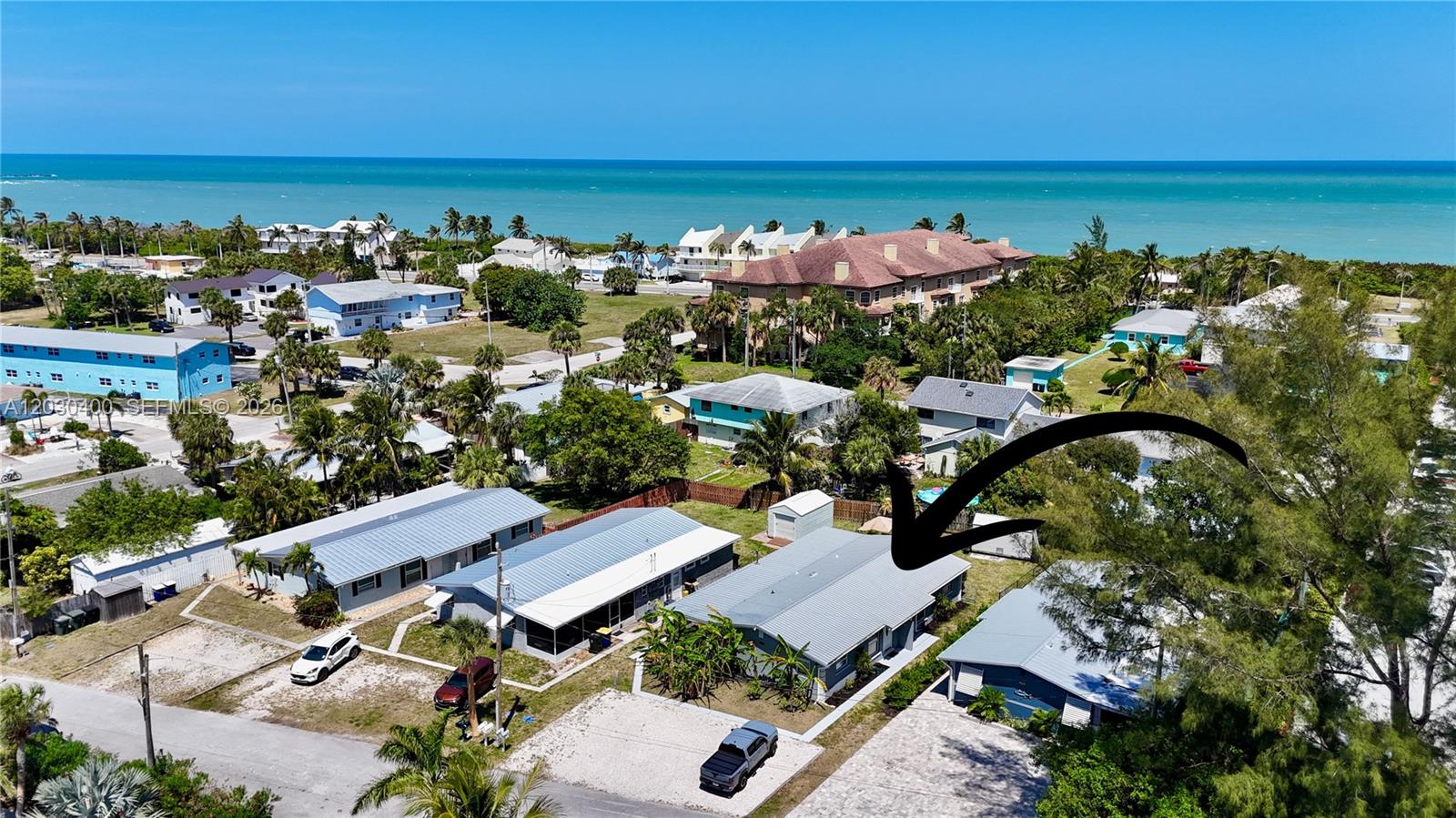An aerial view shows a residential neighborhood with a gray-roofed house highlighted by an arrow — 742 Granada St # A, Fort Pierce FL 34949, FORT PIERCE, FL