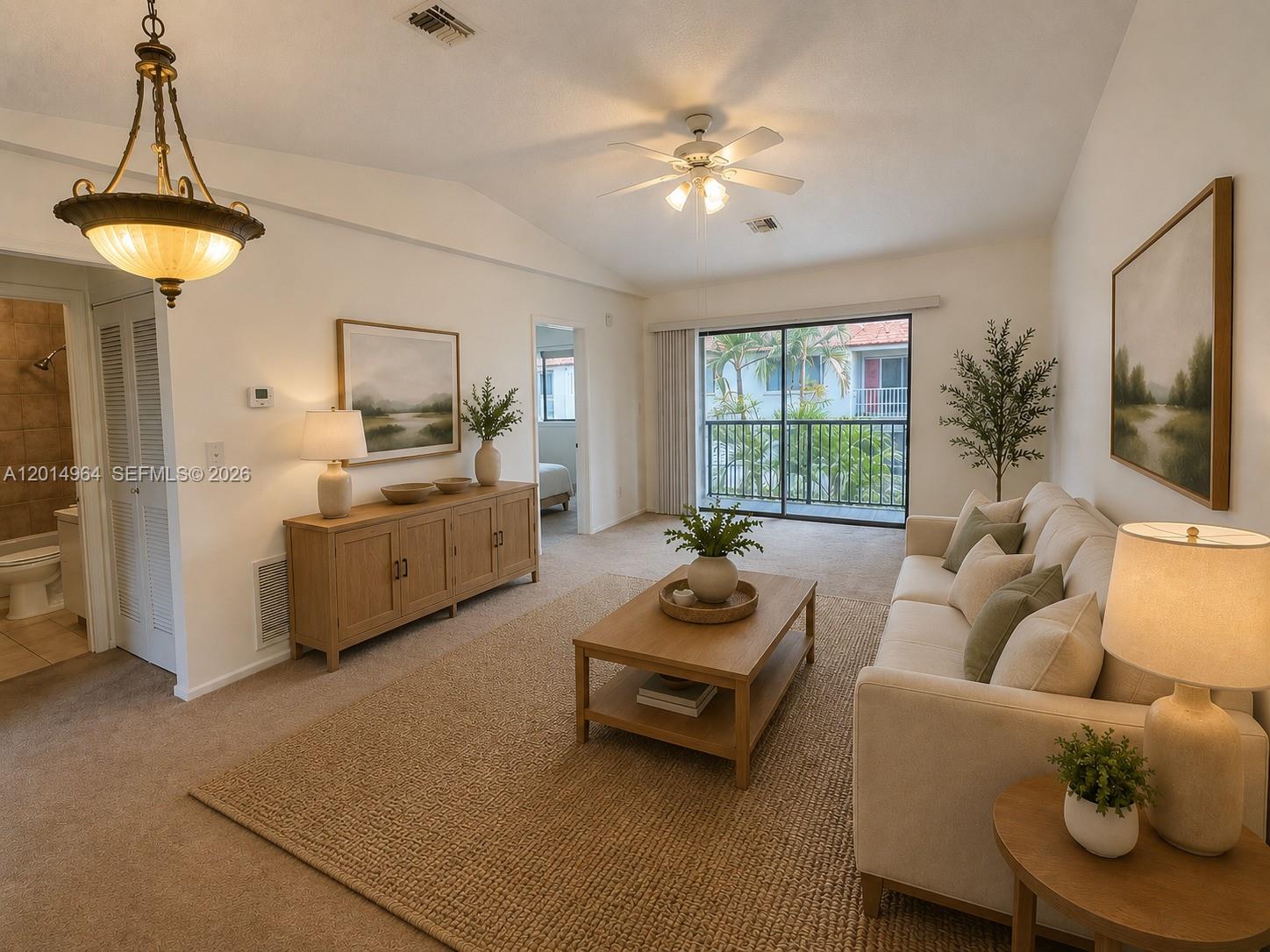 A living room features a beige sofa, wooden coffee table, and a balcony with greenery — 142 NW 60th Ave # 2, Margate FL 33063, MARGATE, FL