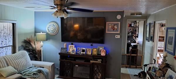 A living room features a wall-mounted television, a media console, and a ceiling fan — 1785 SW Diana Terrace, Stuart FL 34997, STUART, FL