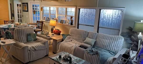 A living room features a light-colored sectional sofa, a matching armchair, and a dining area — 1785 SW Diana Terrace, Stuart FL 34997, STUART, FL