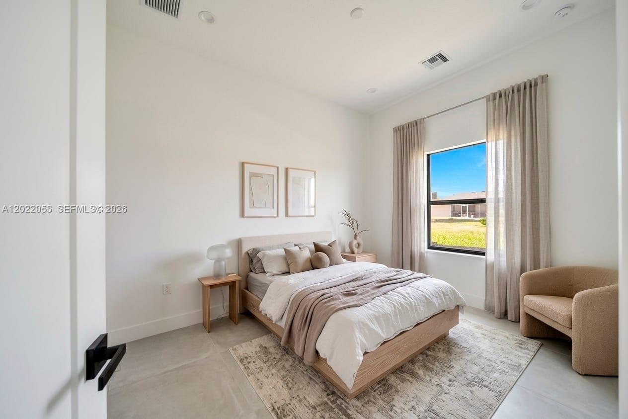 A modern bedroom features a platform bed, neutral decor, and a large window with curtains — 3286 EAGLE PASS ST, North Port FL 34286, NORTH PORT, FL