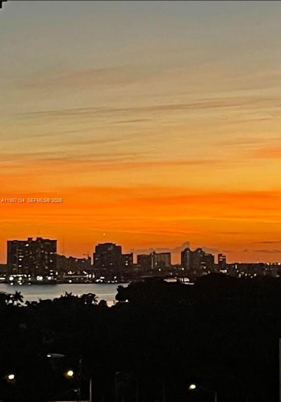 A view of a city skyline across a body of water during a sunset — 6061 Collins Ave # 12D, Miami Beach FL 33140, MIAMI BEACH, FL