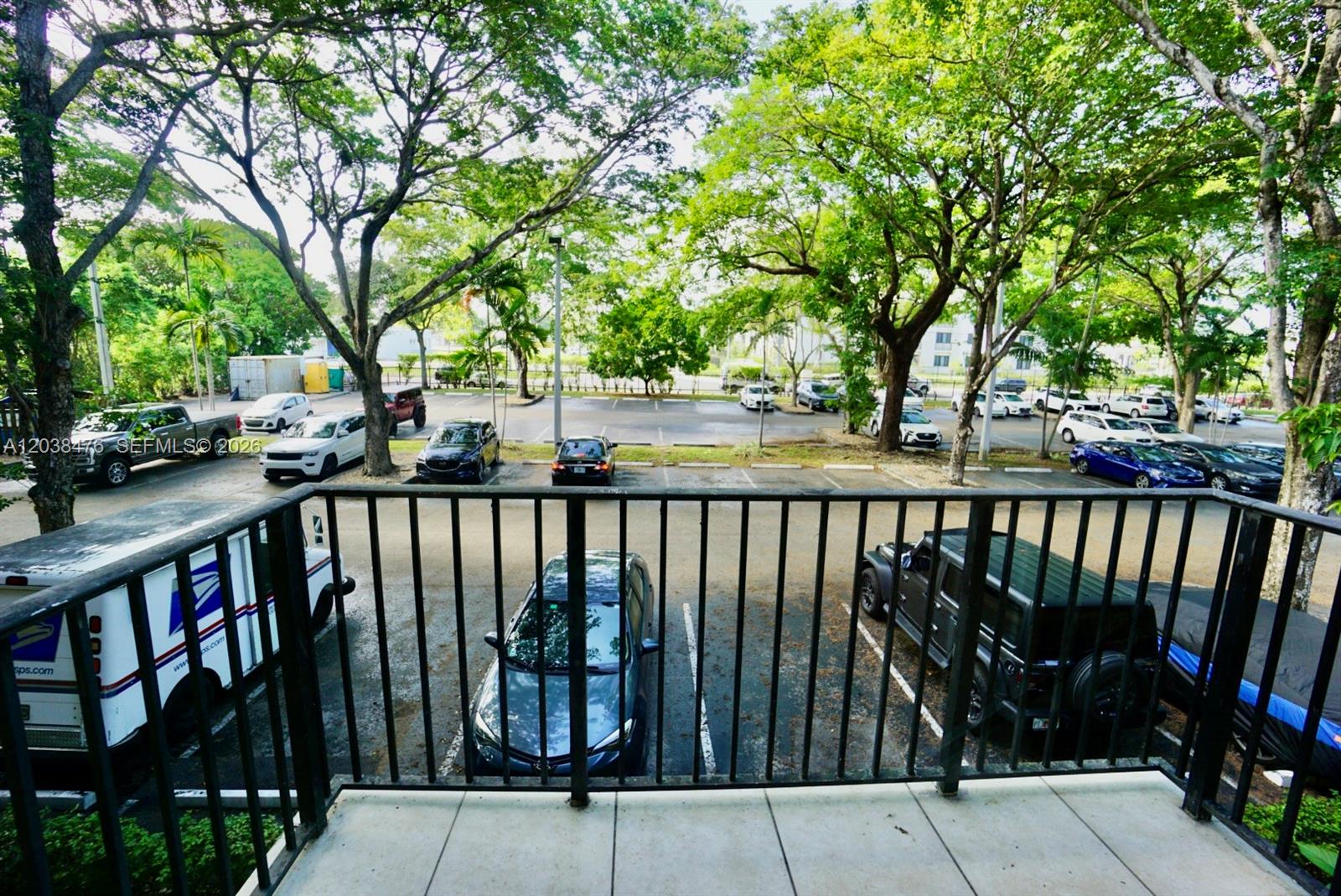 A view from a balcony overlooking a parking lot with several cars and trees — 8500 SW 109th Ave # 225, Miami FL 33173, MIAMI, FL