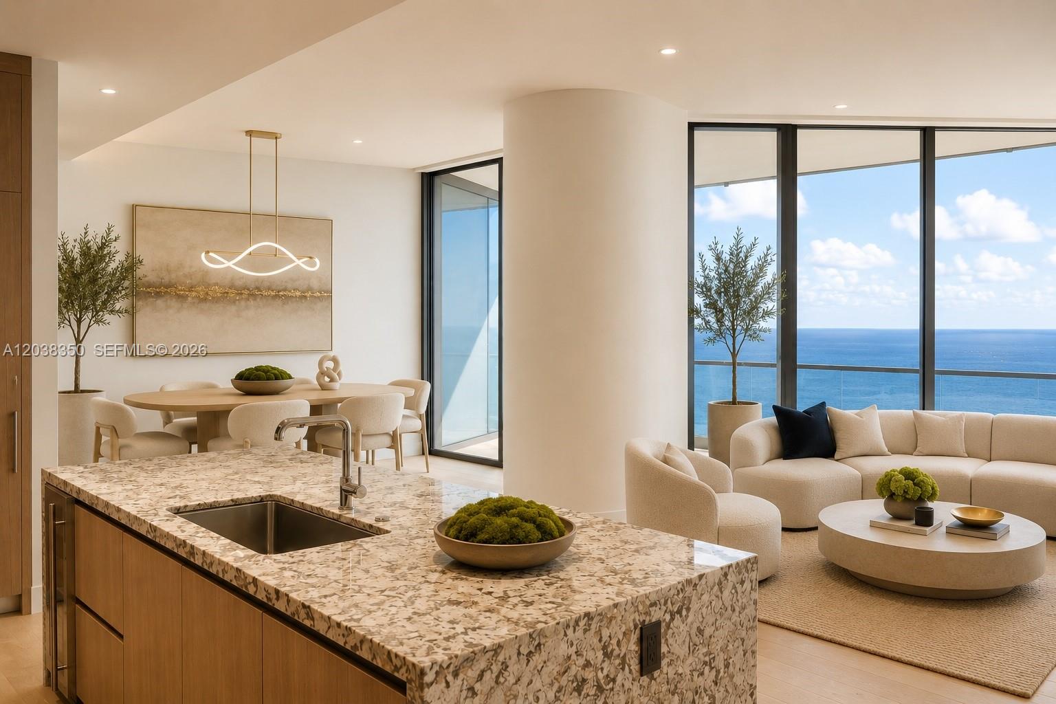 A modern open-concept kitchen and living area features granite countertops, light wood cabinetry, and ocean views — 175 SE 25th Rd # 3103, Miami FL 33129, MIAMI, FL