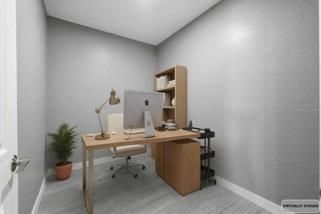 This virtually staged home office features a desk, chair, bookshelf, and light gray tile flooring — 2683 HOPWOOD ROAD, NORTH PORT, FL
