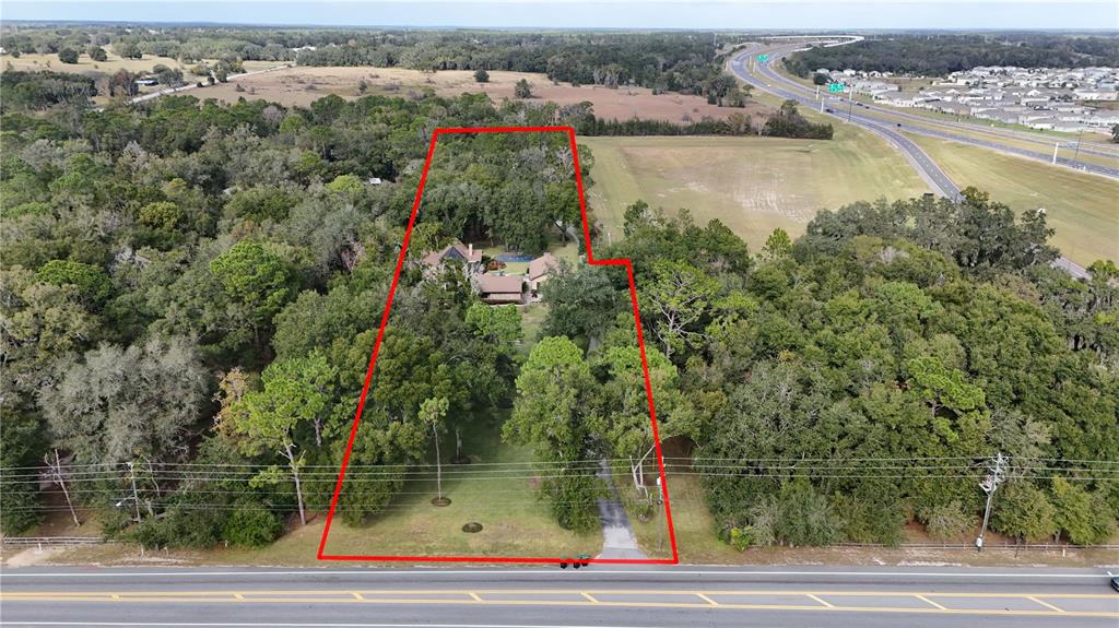 An aerial view shows a house surrounded by trees on a large, rectangular lot — 3525 W KELLY PARK ROAD, APOPKA, FL