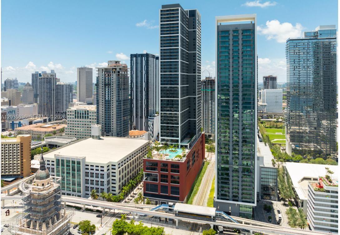 An aerial view of a modern high-rise building complex in a dense urban city setting — 601 NE 1st Ave # 1720, Miami FL 33132, MIAMI, FL