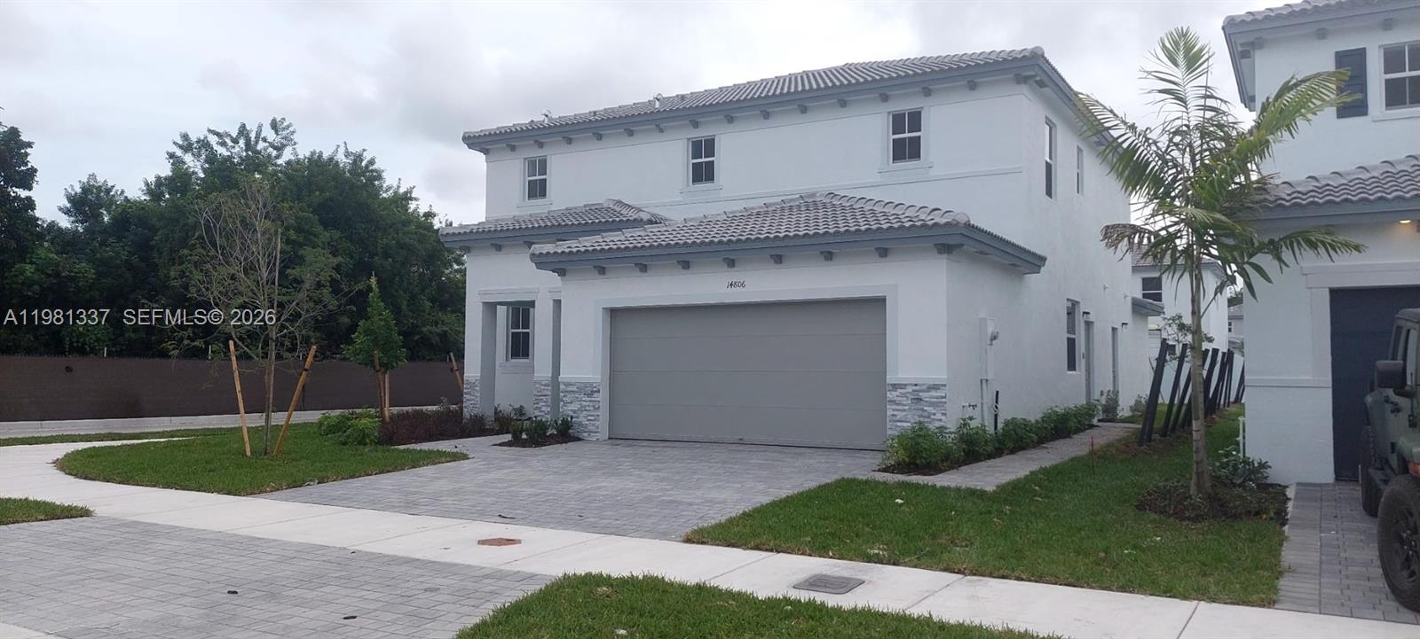 A two-story white house features a gray tiled roof, a two-car garage, and stone accents — 14806 SW 163rd St, Miami FL 33187, MIAMI, FL