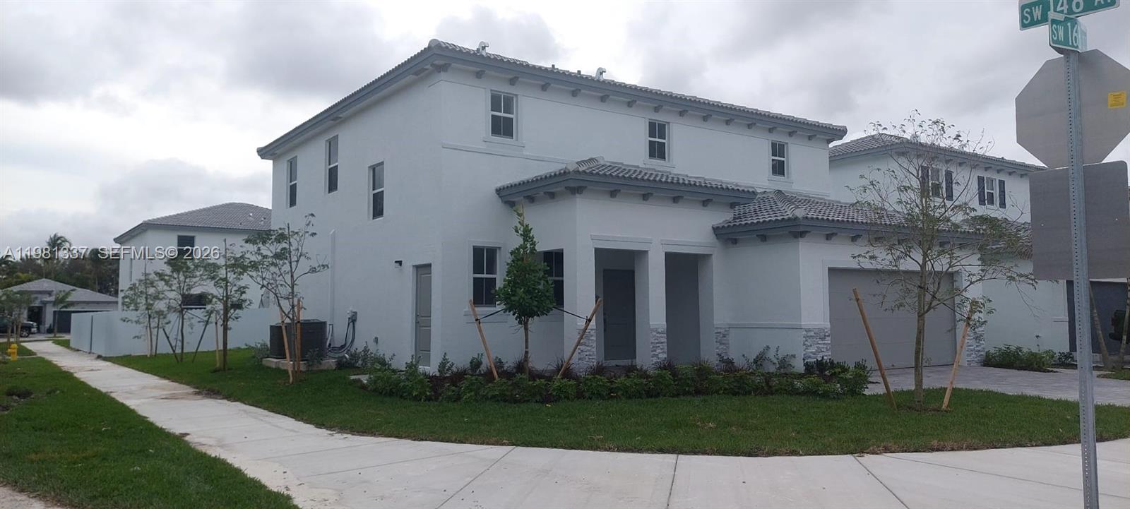 A two-story white stucco house with a gray tile roof and an attached garage — 14806 SW 163rd St, Miami FL 33187, MIAMI, FL