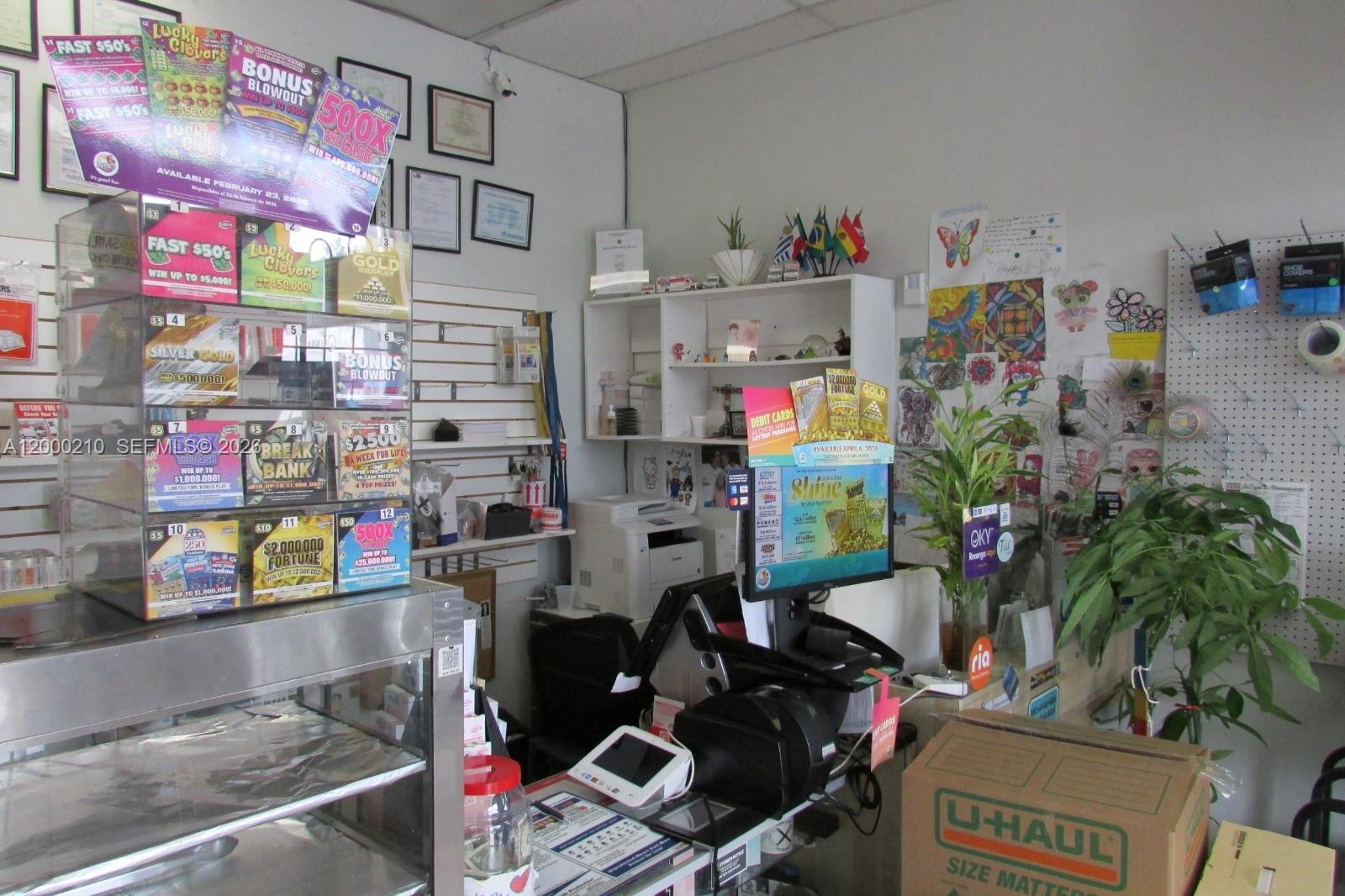 A retail counter area features a lottery ticket display, a computer monitor, and U-Haul boxes — 4330 SW 8th St, Coral Gables FL 33134, CORAL GABLES, FL