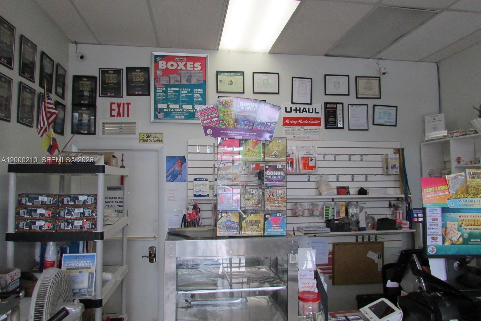 A retail counter area features a lottery ticket display, U-Haul signage, and various wall certificates — 4330 SW 8th St, Coral Gables FL 33134, CORAL GABLES, FL