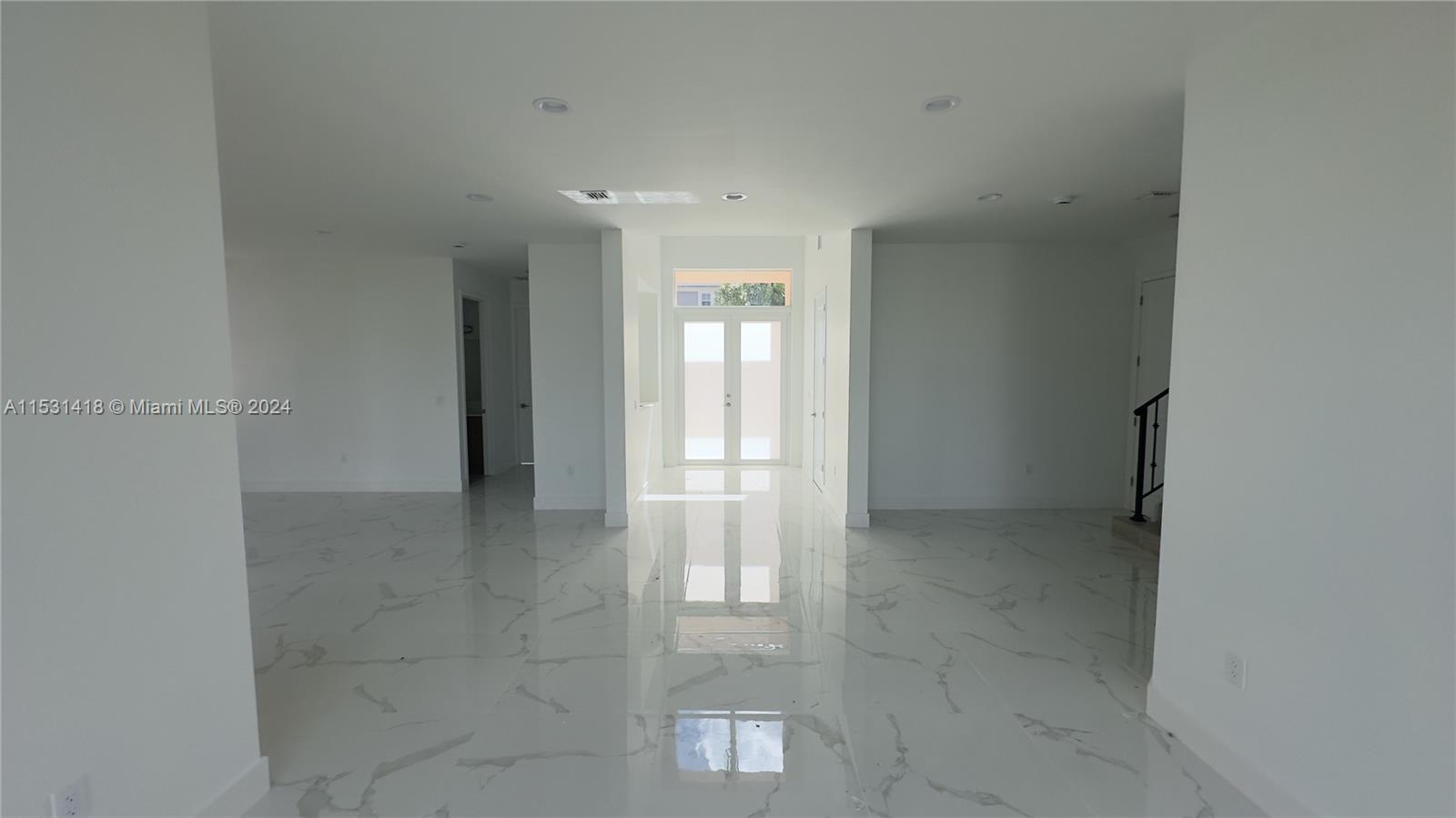 An empty room features white walls, recessed lighting, and polished white marble-look tile flooring — 3523 Forest View Cir, Dania Beach FL 33312, DANIA BEACH, FL
