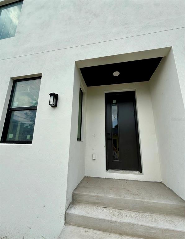 An aerial view shows two modern, multi-story white townhomes with flat roofs and a central driveway — 310 W COLUMBUS DRIVE UNIT 7, TAMPA, FL