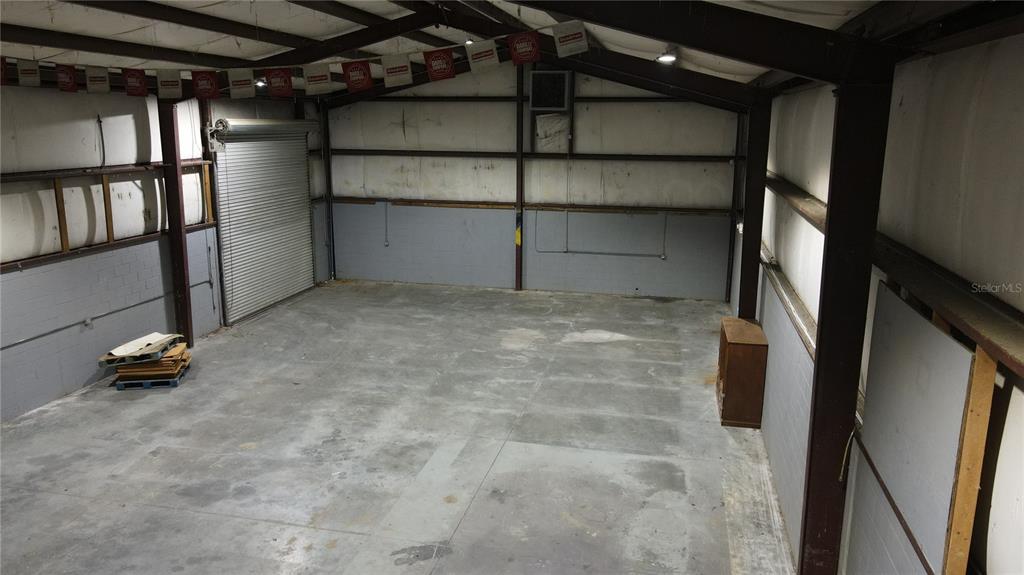 An interior view of a large, open metal warehouse space with concrete floors and walls — 3720 NE 47TH PLACE, OCALA, FL