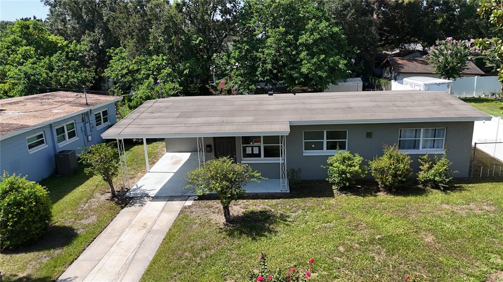 An elevated view of a single-story house with a carport and a flat roof — 3126 KELVINGTON DRIVE, ORLANDO, FL