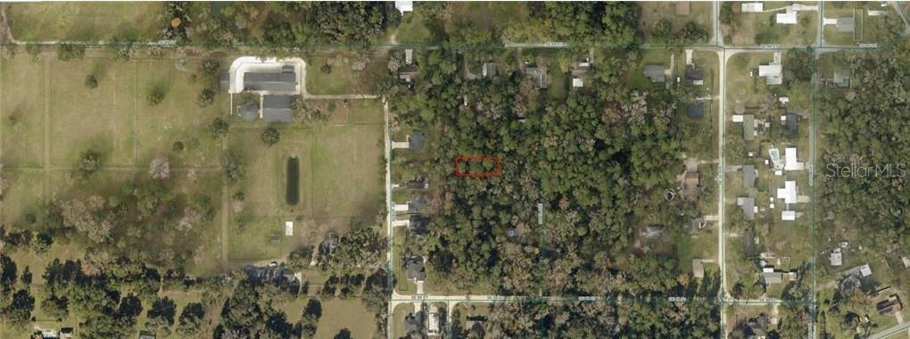 This is an aerial map view showing a wooded lot outlined in red — 3637-004-018 SE 22ND COURT, OCALA, FL