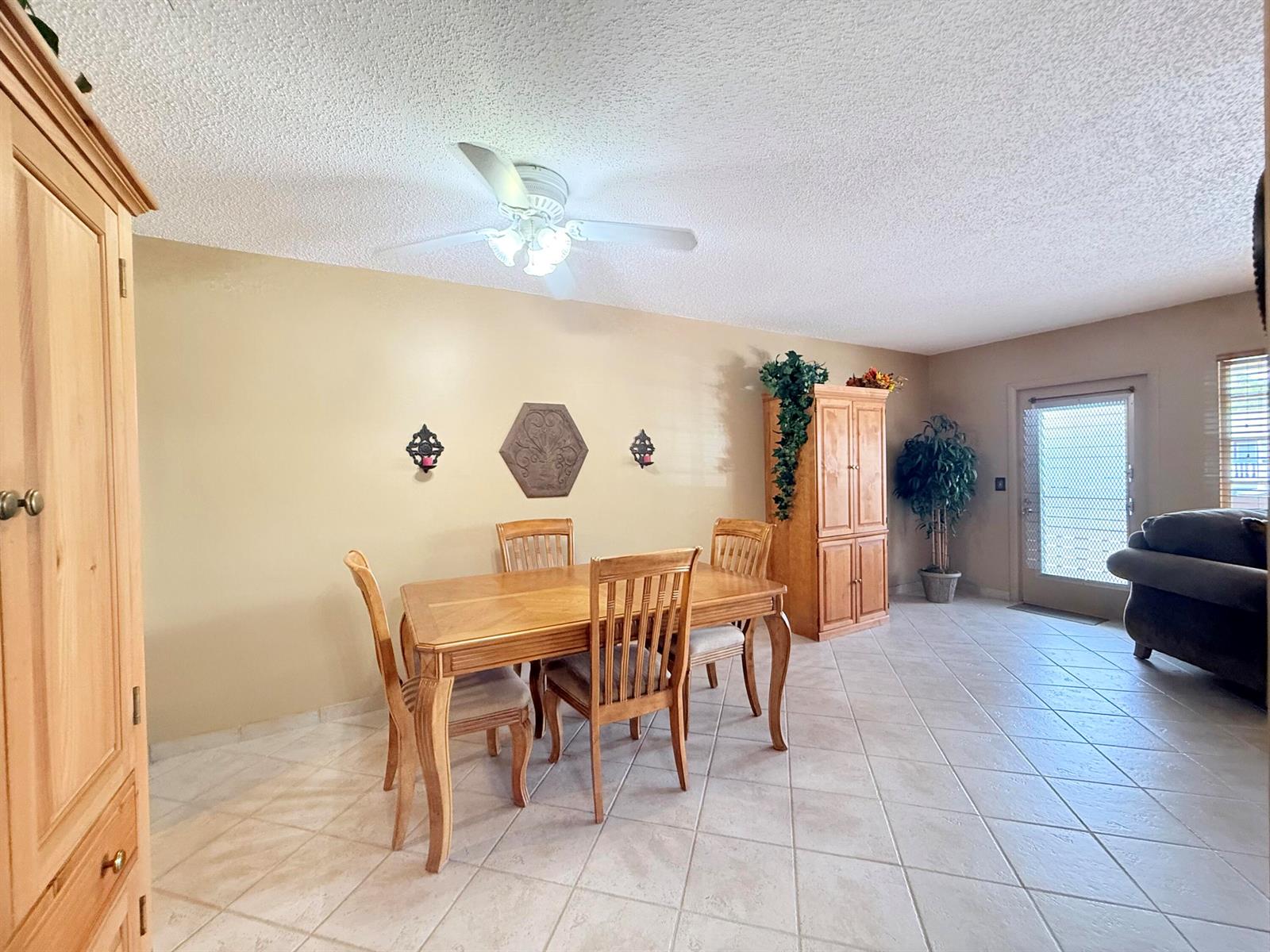 A dining room with a wooden table, chairs, tile flooring, and a ceiling fan — 165 Tilford H # 165, Deerfield Beach FL 33442, DEERFIELD BEACH, FL