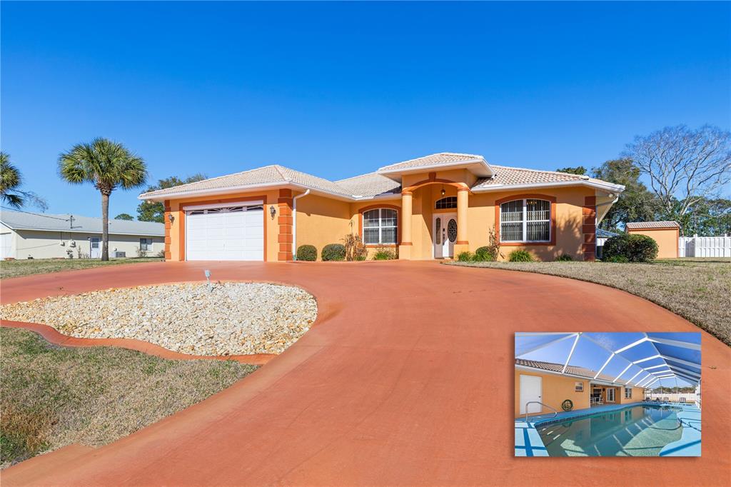 A single-story orange house with a white garage and a driveway, featuring an inset pool — 34 WOODFIELD DRIVE, PALM COAST, FL