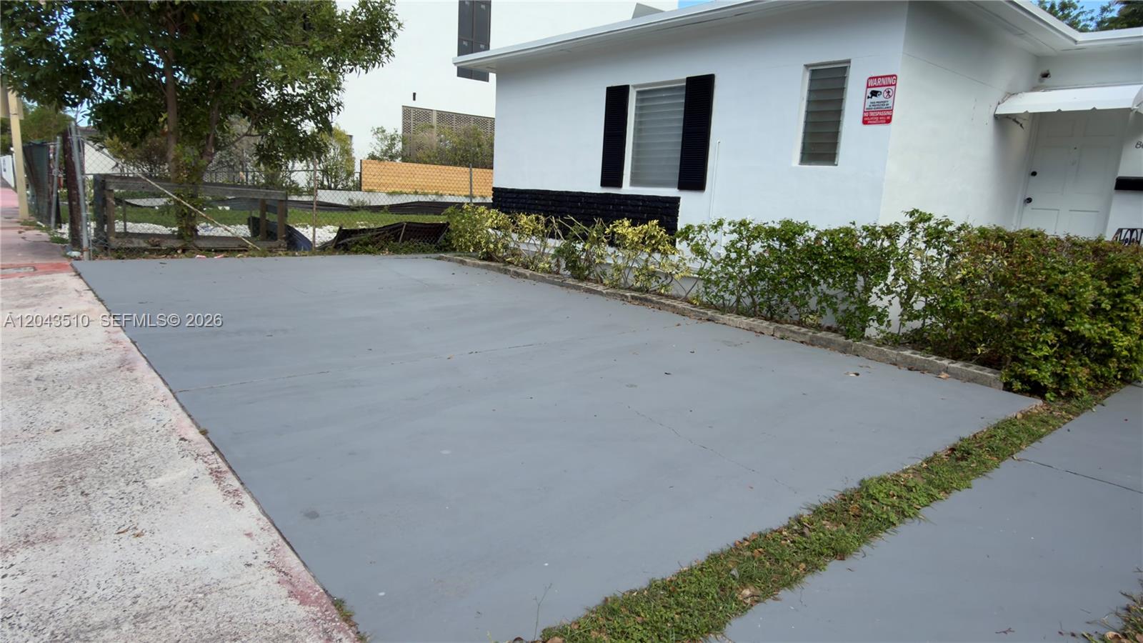 A paved driveway sits in front of a white house with black shutters — 808 84th St # 808, Miami Beach FL 33141, MIAMI BEACH, FL